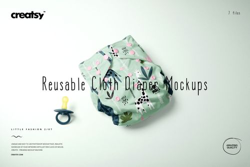 PSD mockup of a baby cloth diaper with colorful forest motifs, displayed on a pale surface with a pacifier as a prop.