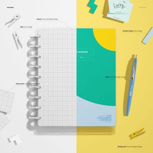 PSD mockup showing a spiral-bound planner and various stationery objects arranged on a divided yellow and white surface.