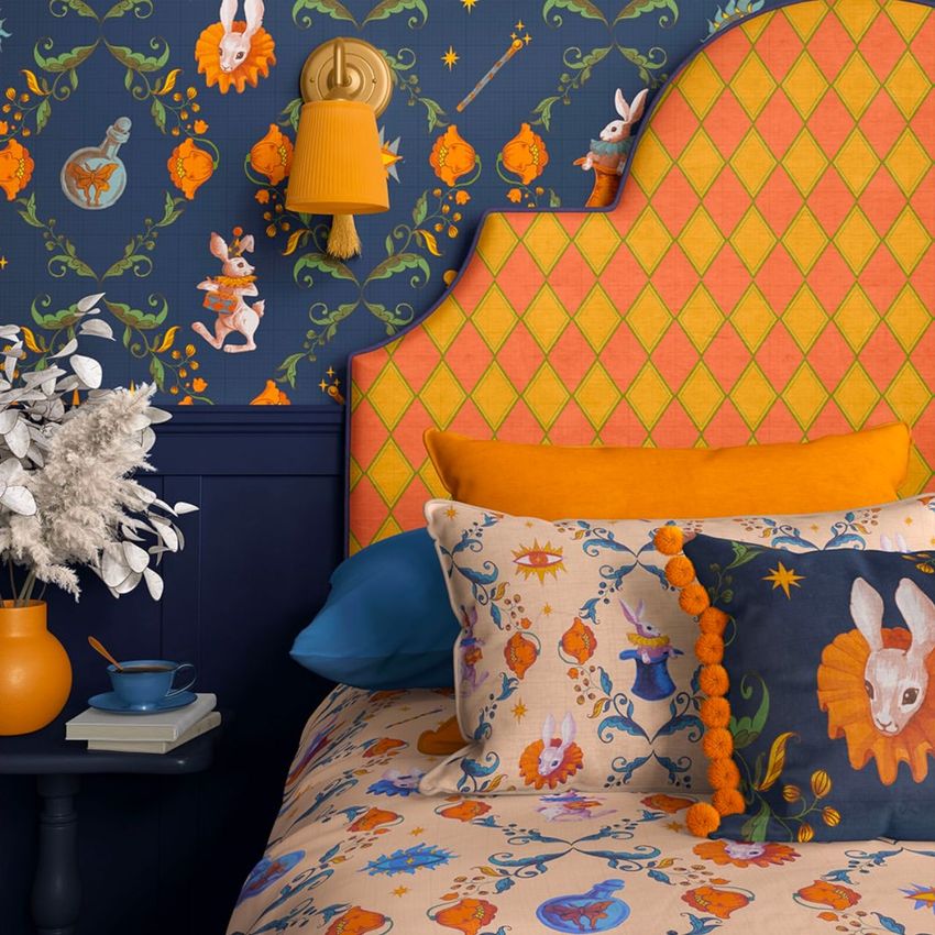 Bedroom pillow, headboard, and wallpaper mockup featuring orange and blue tones with whimsical animal and floral patterns.
