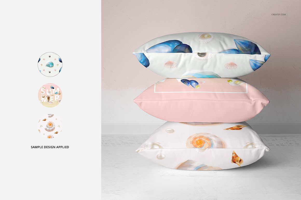 PSD mockup of three throw pillows with ocean-inspired prints, displayed against a light pink wall and white floor.