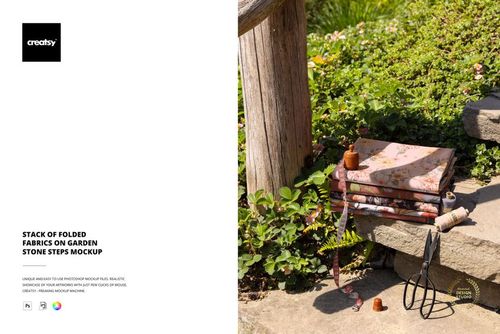 PSD mockup of patterned fabrics stacked on garden steps, with sunlight, foliage, and sewing tools in the scene.
