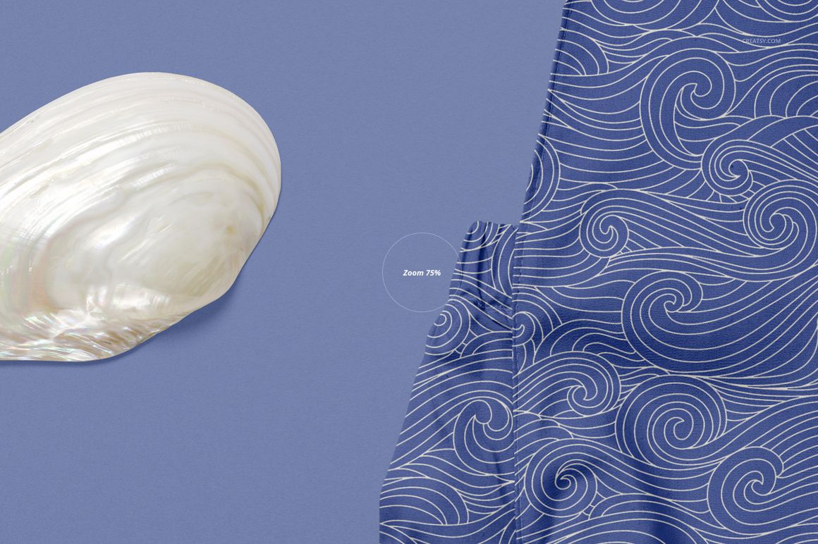 Close-up of a blue baby romper mockup with white wave pattern, next to a large seashell on a solid background.