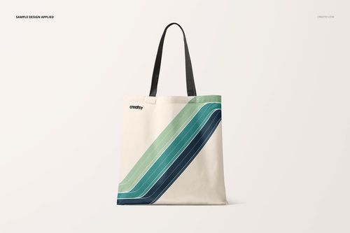 Front view of a tote bag mockup with black handles and diagonal green and blue stripes on a light background.