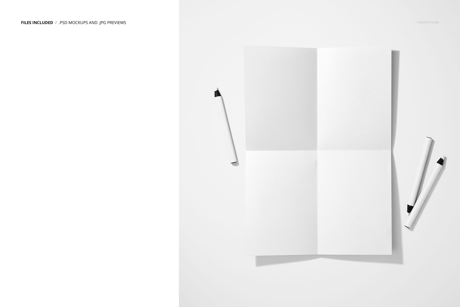 Folded blank poster mockup displayed on a white surface with three crayons scattered nearby, top view.