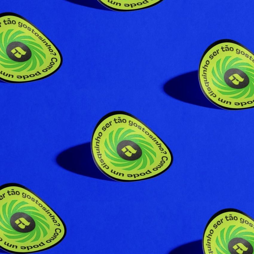 Sticker mockup featuring multiple round stickers with green and yellow patterns on a vibrant blue background, viewed from above.