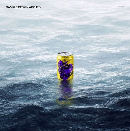 PSD mockup of a drink can with vibrant yellow and purple design floating on the surface of open water.
