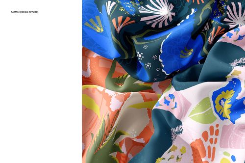 Close-up view of silk fabric mockup featuring vibrant floral and botanical patterns in blue, green, pink, and peach tones.