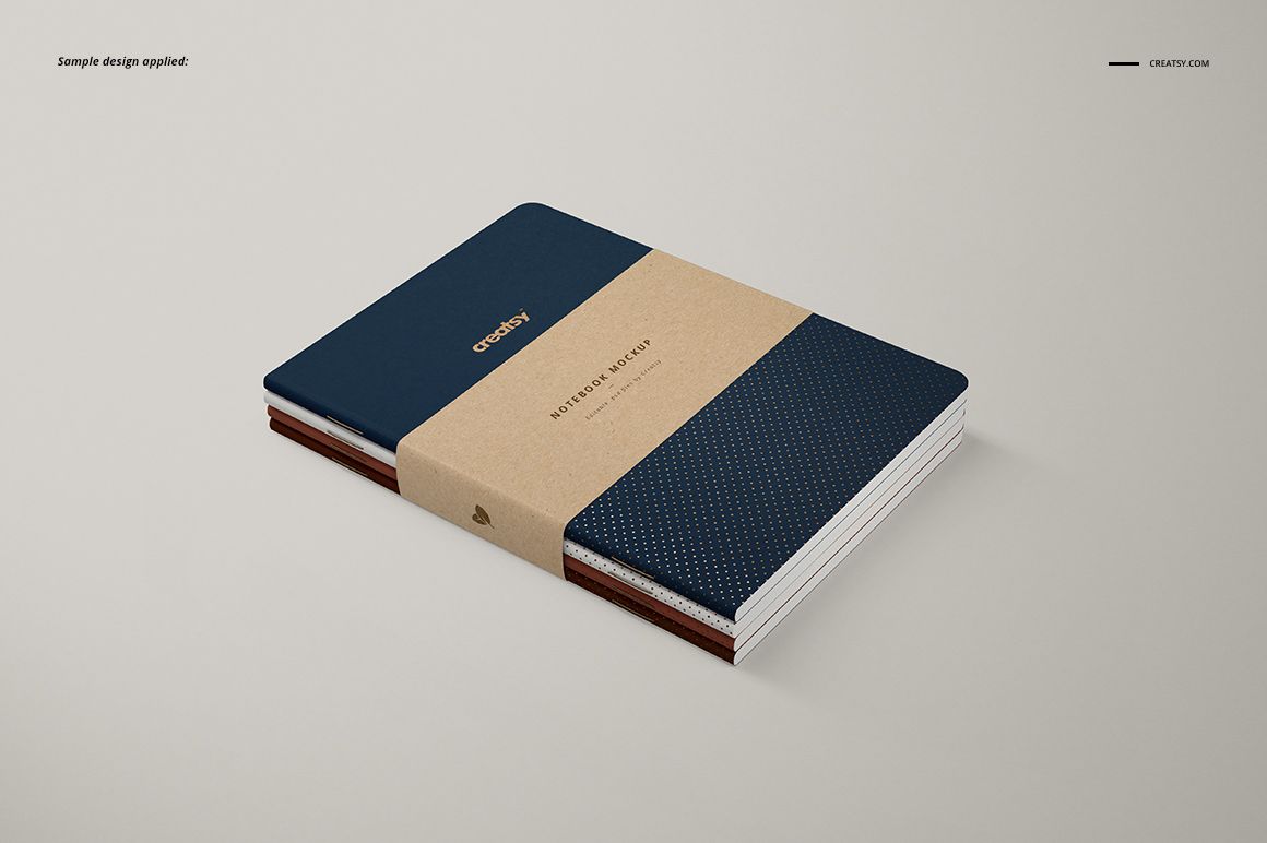 A5 classic notebook PSD mockup featuring a navy blue dotted cover, kraft wrap band, and clean minimalist background.