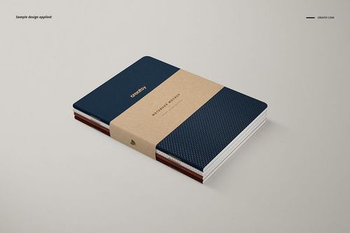 A5 classic notebook PSD mockup featuring a navy blue dotted cover, kraft wrap band, and clean minimalist background.