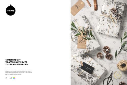 PSD mockup showing Christmas gifts with botanical wrapping, olive branches, pinecones, and festive twine on a light surface.