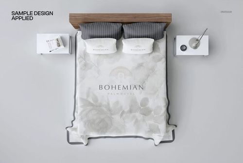 Top view of a plain bed coverlet mockup on a double bed with two pillows, gray headboard, and white nightstands.