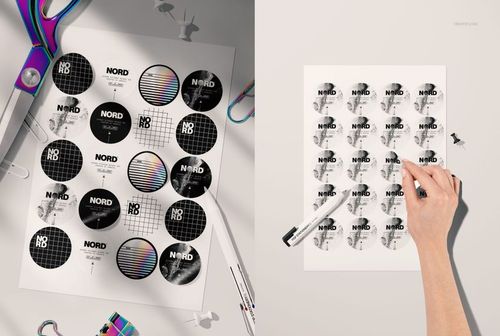 Hand peeling a round sticker from a sheet featuring assorted black, white, and holographic patterns in a PSD mockup.
