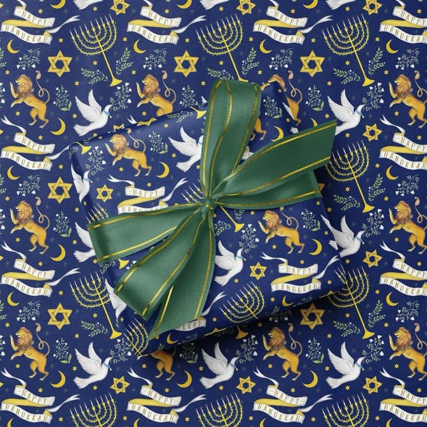 Square gift box mockup wrapped in blue paper with Hanukkah-themed illustrations, topped with a green ribbon and bow.