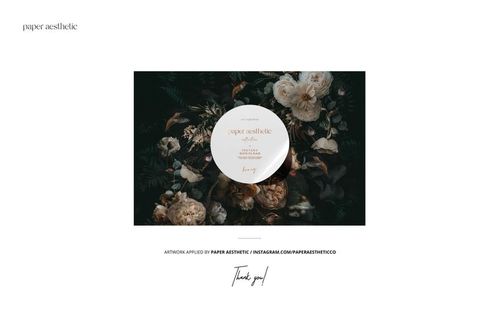 Glass candle mockup displayed with a circular label, surrounded by lush dark foliage and pale roses.