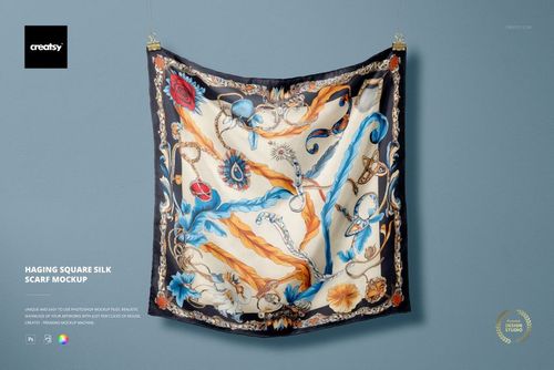 PSD mockup of a decorative silk scarf displayed flat on a wall, showcasing swirling motifs and dark border.