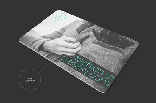 Rectangular gift card mockup with grayscale photo and teal text, shown from an angled top perspective on a dark background.