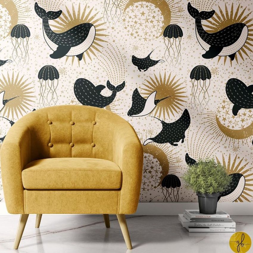 Interior scene mockup featuring a mustard yellow armchair in front of a patterned wallpaper with black and gold whales, jellyfish, and starburst motifs.