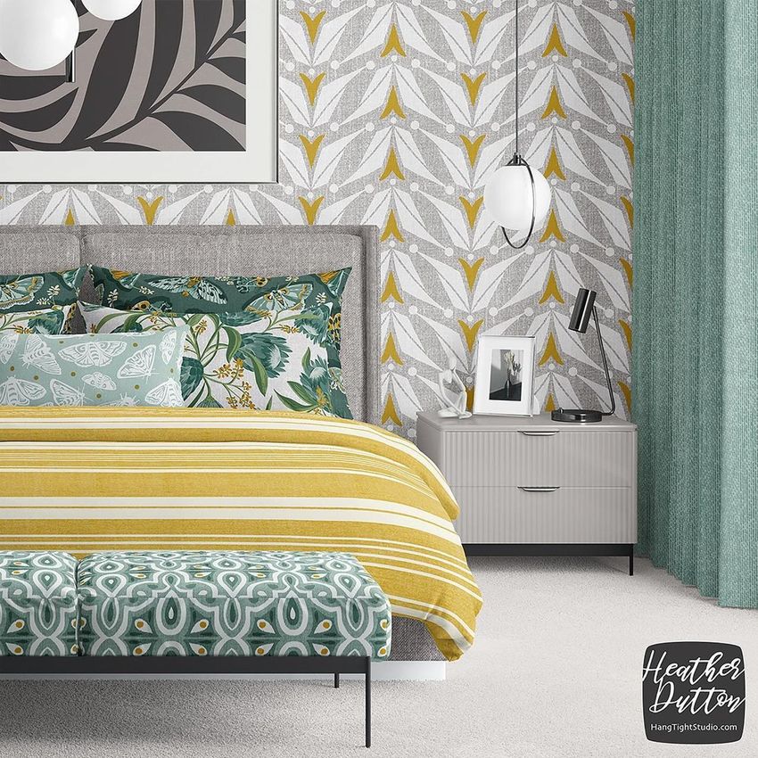 Bedroom scene bedding mockup featuring a bed with patterned pillows and a yellow striped duvet, set against a leafy wallpaper.