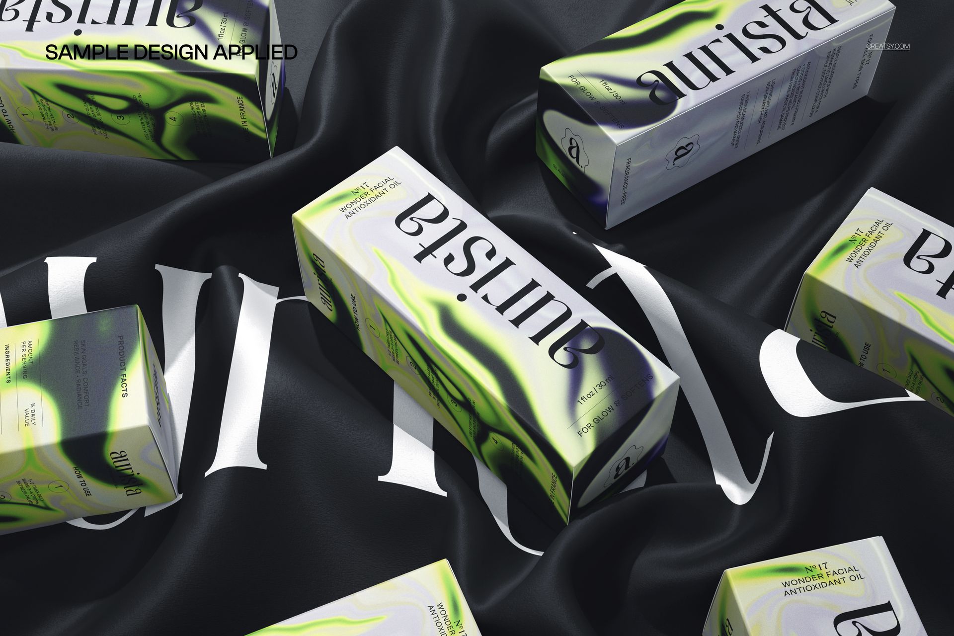 Multiple packaging boxes featuring green and black patterns displayed on a smooth, dark silk background in a mockup.