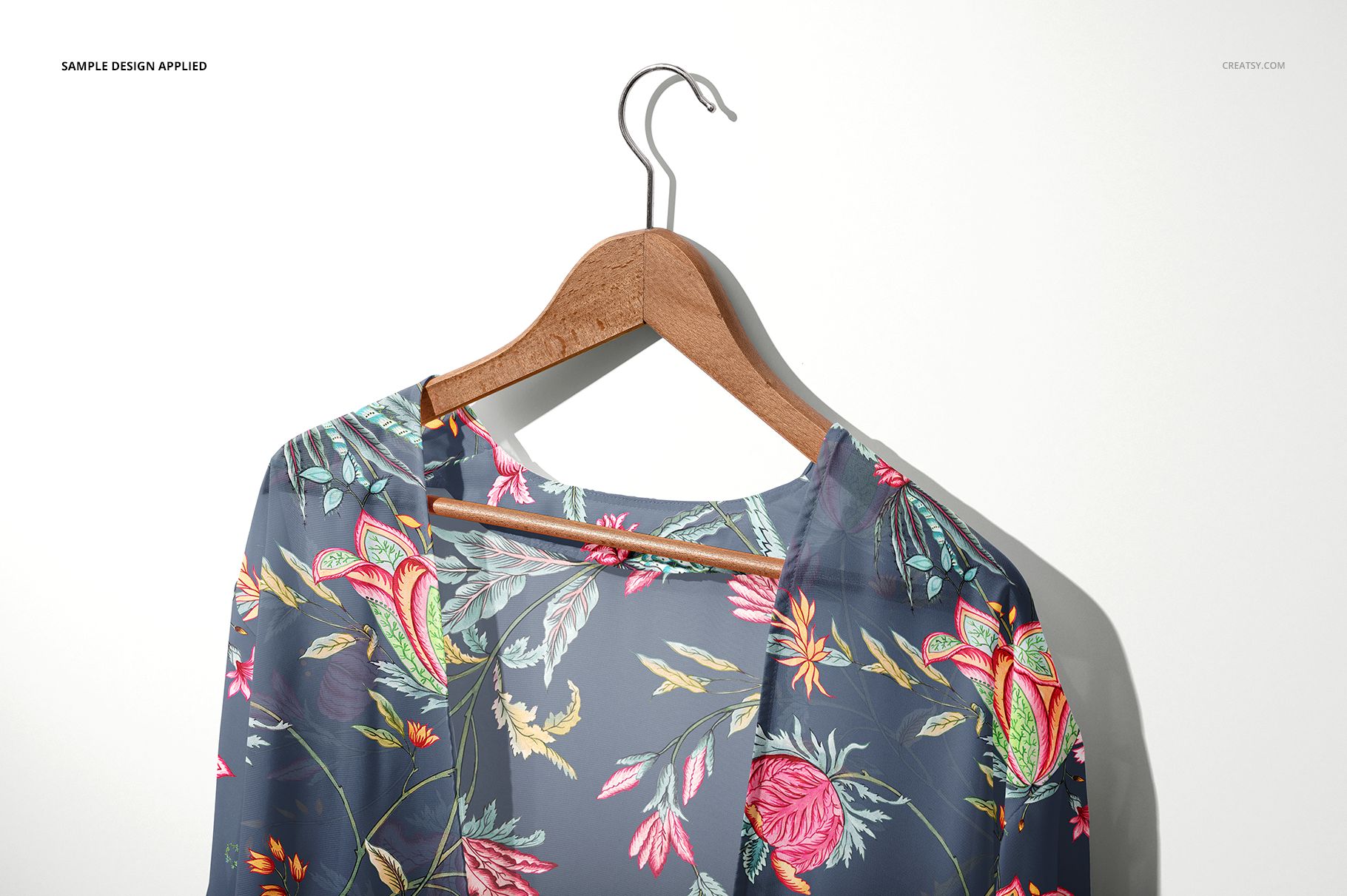 Front view of a chiffon kimono mockup featuring a vibrant botanical print, displayed on a hanger against a light background.