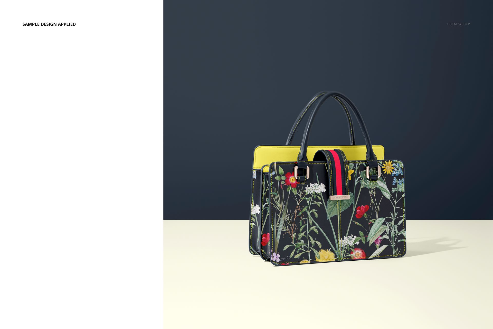 Front view of a leather handbag mockup with floral pattern, black handles, and yellow accents on a neutral surface.