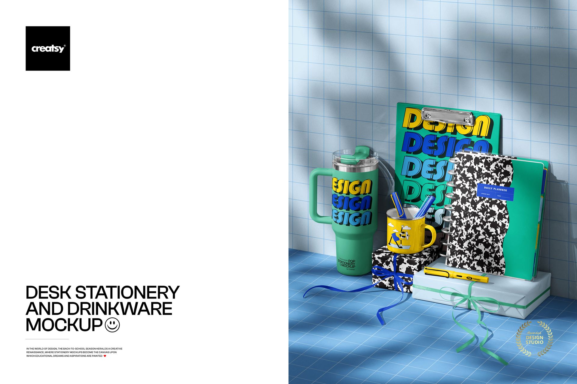 Front view of a stationery and drinkware mockup featuring notebooks, cup, tumbler, and pencils on a blue grid desk.