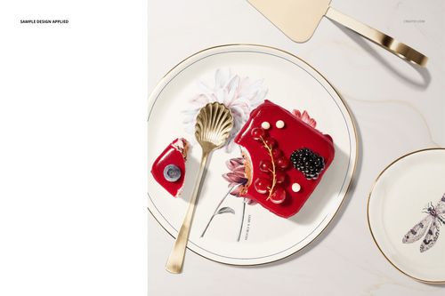 Top view of a round plate mockup with a floral design, gold rim, and pastry slice, accompanied by a gold fork.