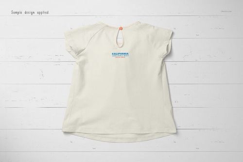 Back view of a short-sleeve baby t-shirt mockup in light cream color, displayed on a white wooden surface.