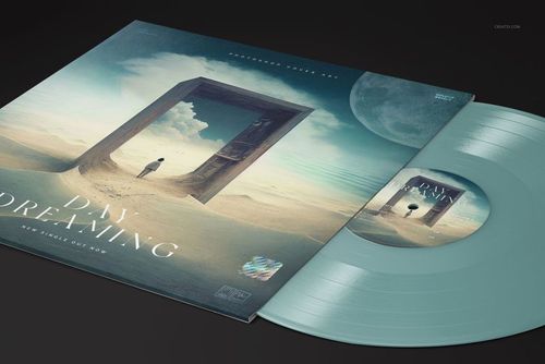Close-up of a colored vinyl record mockup set showing a pastel blue disc and a cover with a surreal desert scene.