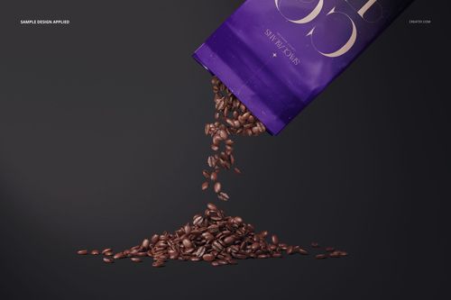 Glossy coffee bag mockup shown at an angle with coffee beans spilling out onto a dark surface.
