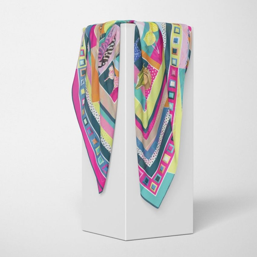 Silk scarf mockup featuring a colorful patterned scarf draped over a tall white pedestal against a plain light background.