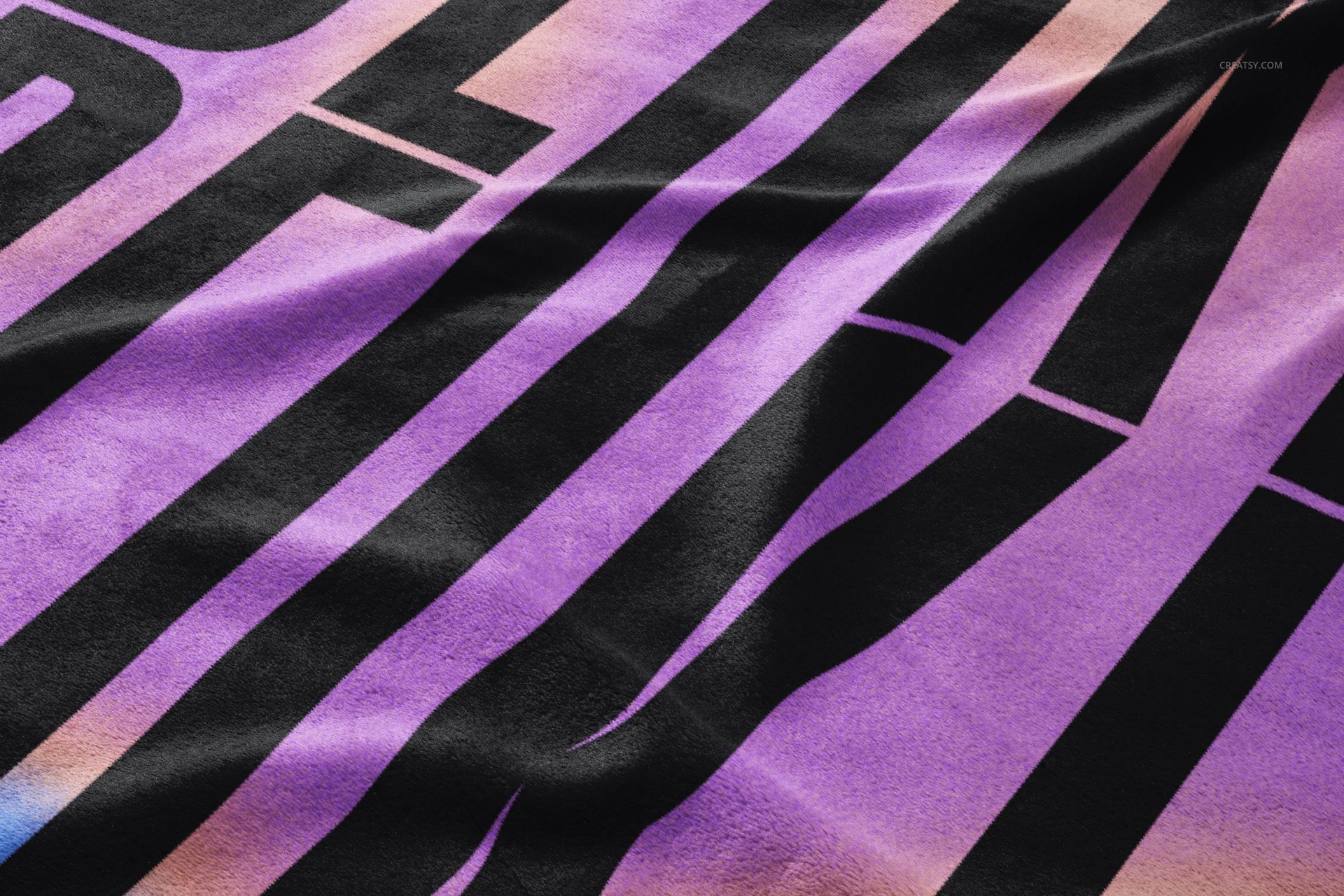 Close-up view of a fleece blanket mockup with large black geometric stripes on a purple and peach gradient background.
