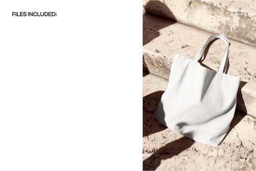 Light canvas tote bag mockup placed on textured stone steps, photographed from a slightly elevated front view.