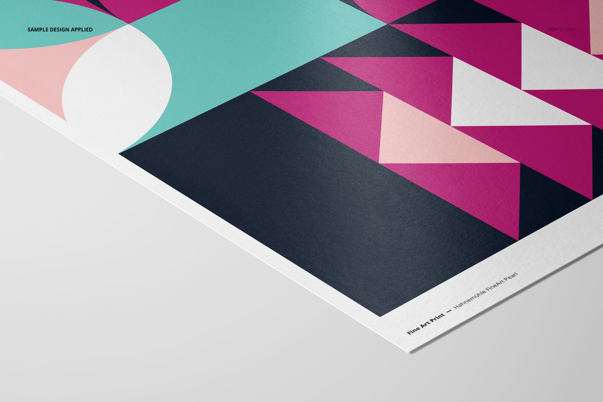 A3 fine art print mockup featuring geometric shapes in teal, pink, white, and black, angled on a light surface.