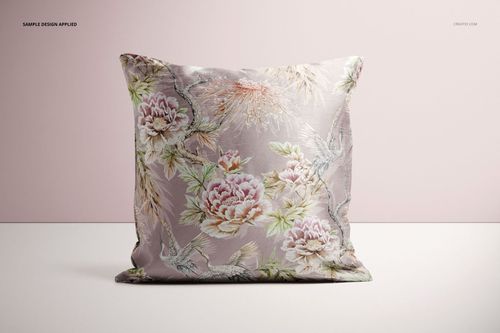Front-facing mockup of a polyester pillow cover featuring soft pink and green floral designs, set against a pale backdrop.