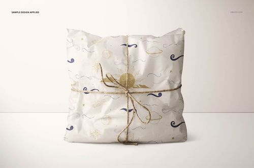 Gift wrapping tissue paper mockup showing a rectangular package wrapped in white paper with stars and planets design.