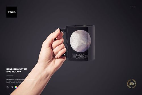 Black ceramic mug mockup held in a hand, displaying a white abstract circle and text, set on a dark backdrop.