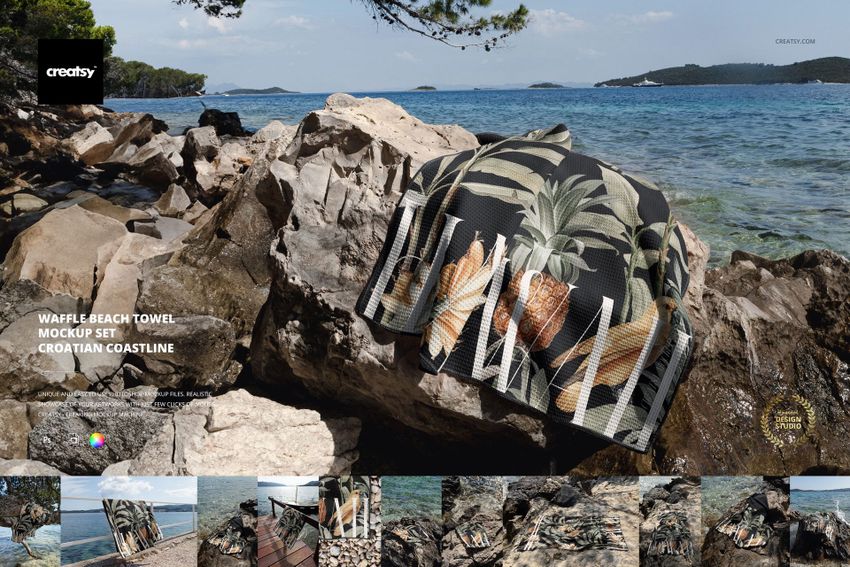Tropical patterned waffle beach towel mockup displayed on large rocks beside the sea, Croatian islands visible afar.