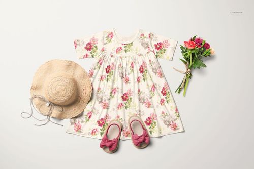 Floral short sleeve swing dress mockup displayed with straw hat, pink sandals, and bouquet on a light background.