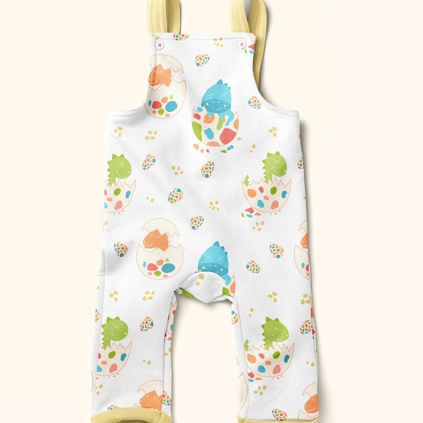 Kids fleece dungarees mockup featuring a playful dinosaur and egg pattern in pastel colors on a light background.