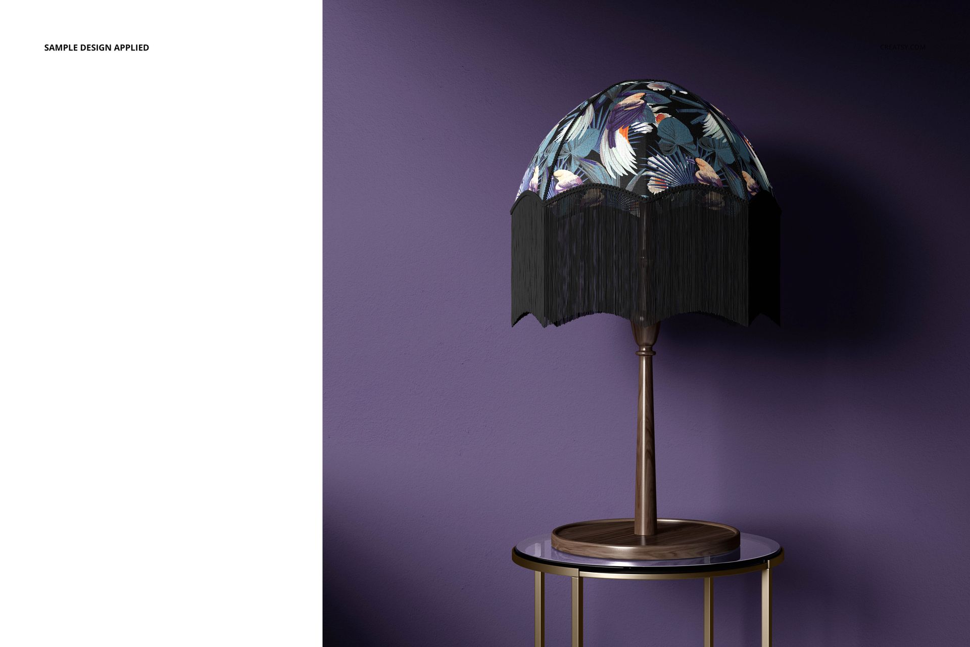 Front view of a mockup table lamp with a dark velvet fringe and colorful botanical design on the lampshade, set in a modern room.