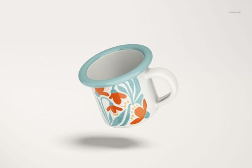 Enamel mug with a blue rim and handle, featuring orange and teal floral patterns, floating on a light background.