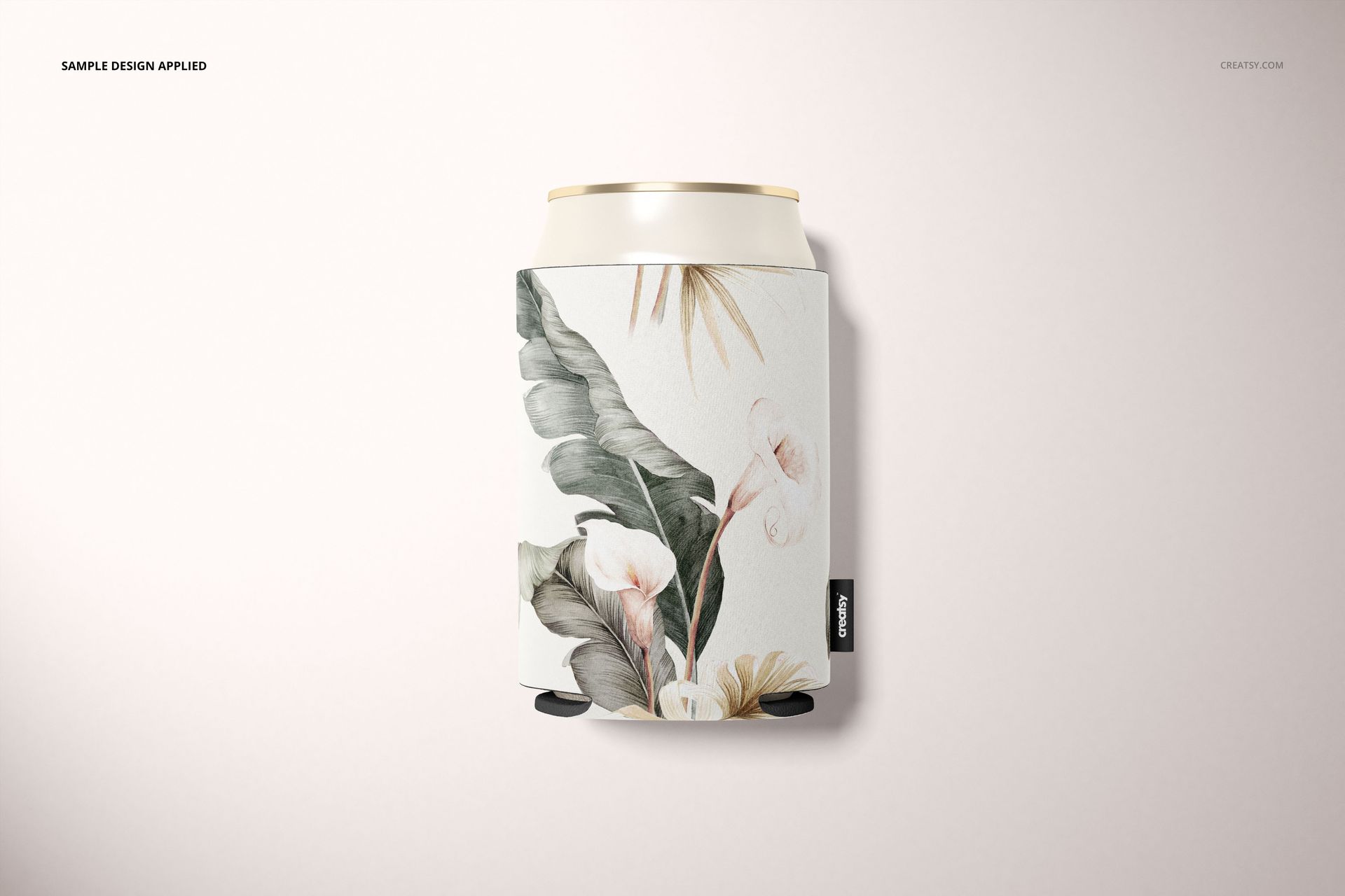 Single neoprene can cooler mockup featuring botanical leaves and flowers, shown upright with soft lighting.