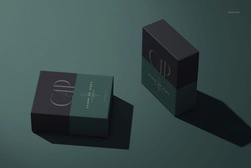 Hotel shower cap packaging mockup featuring two boxes with minimalist dark green and black design, angled perspective.