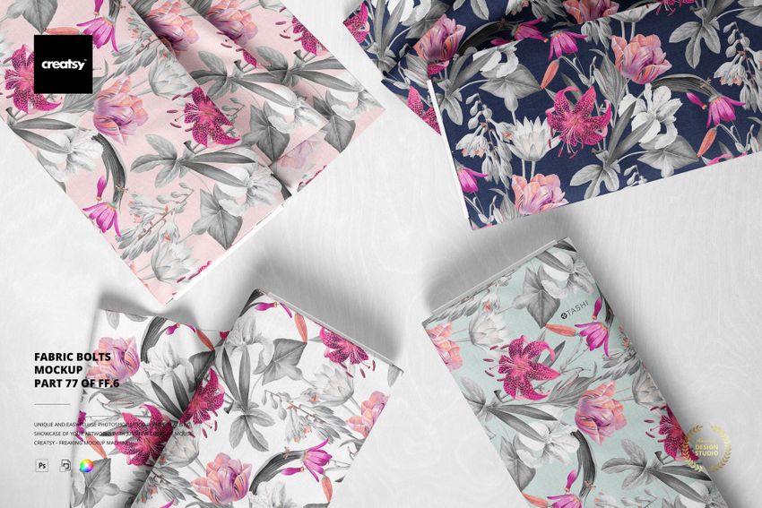 Fabric bolts mockup set showing botanical prints in pink, gray, and navy tones, presented from an overhead perspective.