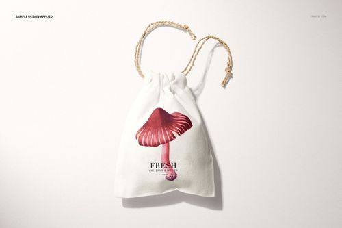 Linen drawstring bag mockup featuring a realistic mushroom illustration and twisted beige drawstrings, top view.
