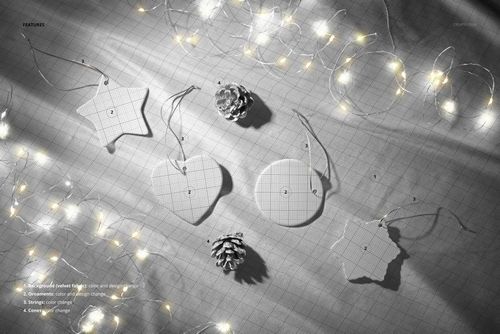 Christmas ceramic ornament PSD mockup featuring star, heart, circle, and tree shapes arranged with festive lights and pinecones.
