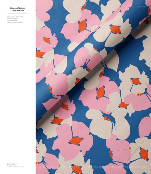 Fabric mockup featuring a large-scale floral design in pink, beige, orange, and blue, displayed from a top angle.
