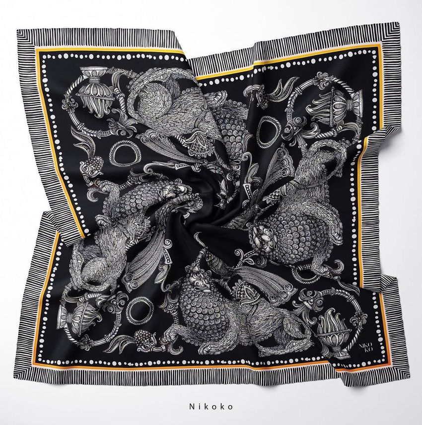 Twill silk scarf mockup featuring an intricate black and white lion illustration with ornate patterns, displayed on a flat surface.