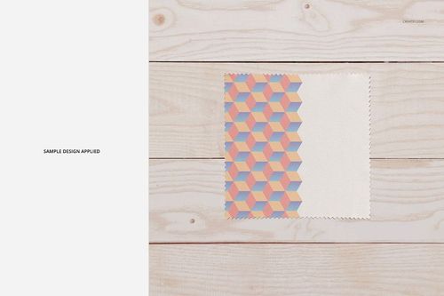Microfiber glasses cleaning cloth mockup featuring a geometric pastel pattern on one half, top view on wooden surface.